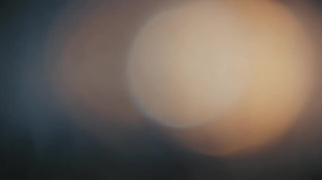 Blurry Light Orbs Moving Across Dark Background.