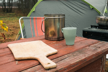 Lakeside camping scene, Camp setup by tranquil waters, Arranged campsite area near peaceful lake...