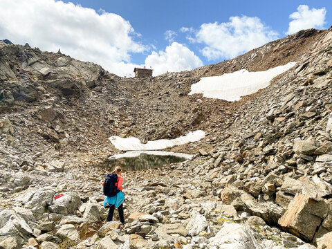 Hiking through the magnificent high mountain landscape with peaks and glaciers of the South Tyrolean Alps in the Antholz Valley near Bruneck, Rieserferner area of ​​the Dolomites, South Tyrol, Italy