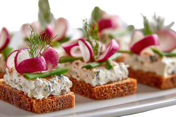 Appetizer crostini with cream cheese, radish, and herbs
