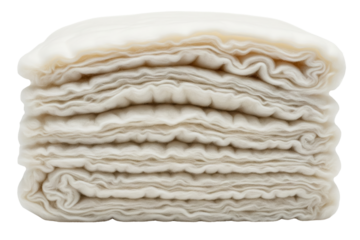 Stack of folded white natural cotton batting fabric layers on a transparent background