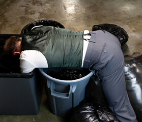 Businessman Laying Atop Pile of Garbage After Being Sacked or Fired. Victim of Stock Market Crash.
