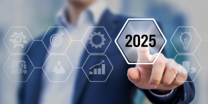 Vision of the Future: An individual's index finger poised to interact with a digital hexagonal button highlighting the year 2025, symbolizing innovative technology and a glimpse into the progress.