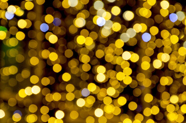 Golden bokeh lights creating sparkling circular glows against dark background, perfect for festive overlays and holiday photography effects. Celebration lighting and atmospheric design themes.