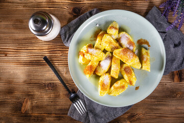 Homemade lazy noodles with cheese, crumbs and melted butter.