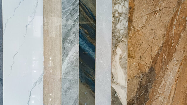 Collection of marble and granite tile samples. Vertical luxury stone textures in white, grey, and brown. Ideal for interior design, flooring, and home renovation concepts.