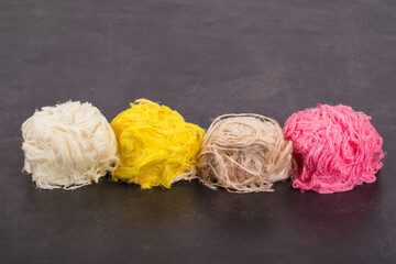 Colored Pismaniye. Light Turkish halva, sweet cotton in the form of threads in a balls. Dark gray background. Close up	