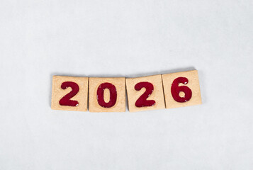 New Year 2026. Holiday Square cookies with red marmalade filling in the shape of the numbers 2026. White background
