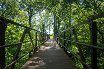Homestead National Historical Park near Beatrice, Nebraska. Unit of National Park Service commemorates American Homestead Act. Site of first successfully claimed acres. Foot bridge over Cub Creek.