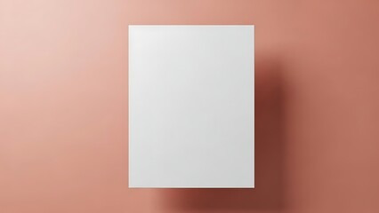 A white rectangular paper on a peach-colored wall with a shadow, viewed from directly above