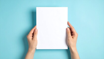 Hands holding a blank white paper on a blue background.