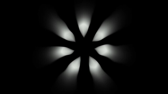 Abstract white glowing blurred radial rays forming a flower shape on black background