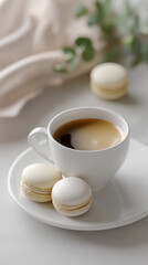 Cup of black coffee with macarons arranged on a clean white surface, symbolizing elegance, lifestyle, and sweet indulgence.
