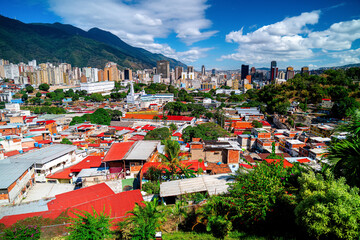 Obraz premium Aerial view of Caracas with barrios and skyscrapers, capital of Venezuela, city struggling economically.