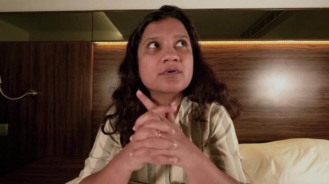 Sad woman dealing with mental health issues and loneliness at night, she is overthinking and stressed at her home  