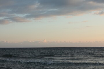 Fototapeta premium Picturesque view of beautiful sky with clouds over sea at sunset
