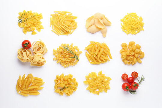 Different types of raw pasta, tomatoes, rosemary and thyme on white table, flat lay