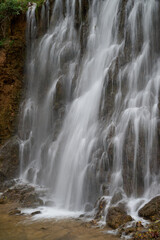 Fototapeta premium Lush historical garden park with waterfalls and ancient pathways at Monasterio de Piedra in Spain