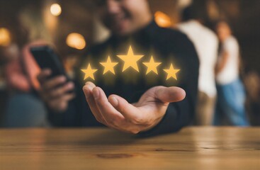 Hand holding glowing golden stars for rating and review concept