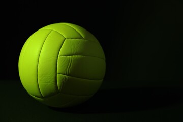 One volleyball ball on dark background. Space for text