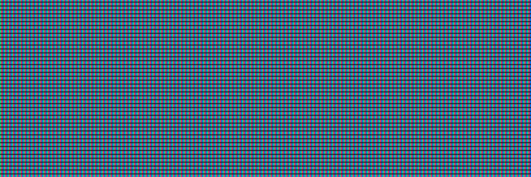 Close-up of rgb pixels on a modern liquid crystal display screen provides a vibrant abstract background texture for tech design