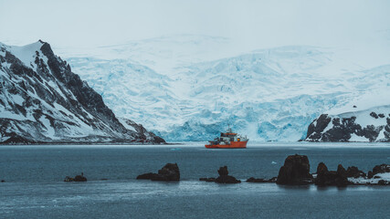 Antarctica Admiralty Bay Wide View Orange Expedition Ship Beautiful Frozen Landscape Glacier Ice and Snow Mountains Epic Adventure Remote Destination © And They Travel