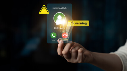 A hand holds a smartphone displaying an incoming call from an unknown number. Warning signs indicate caution, highlighting security concerns in modern communication. Gantry © InfiniteFlow