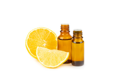 Lemon essential oil in a bottle with sliced ​​lemon and leaves isolated on a white background....