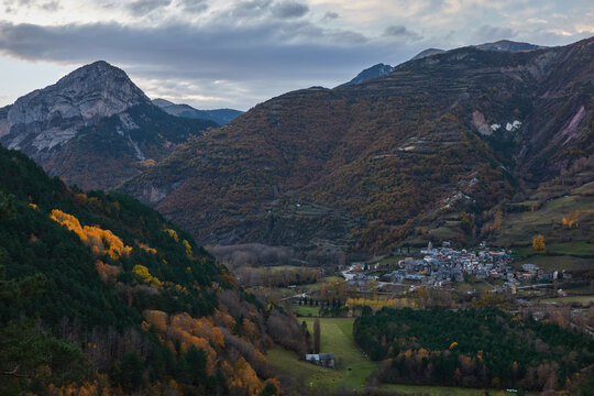 Autumn sunset over Chistau Valley with fall foliage and mountain peaks seen from La Riba viewpoint in the Pyrenees Spain