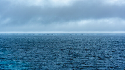 Obraz premium A23a World's Largest Iceberg View From Cruise Ship Misty Clouds Melting Ice Global Warming Climate Change Moody Wide Ocean