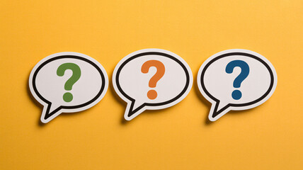 Vibrant question marks in speech bubbles on bright yellow background