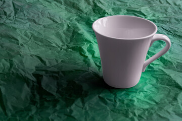 White mug on a green background