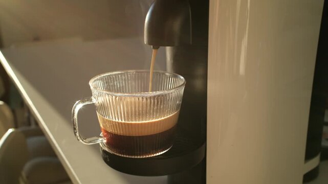 Hands making espresso with modern coffee machine at home