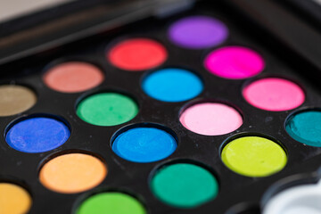 Colorful watercolor paint set with paintbrush