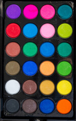 Colorful watercolor paint set with paintbrush