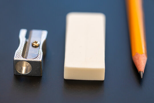 Yellow pencil, metal sharpener and rubber
