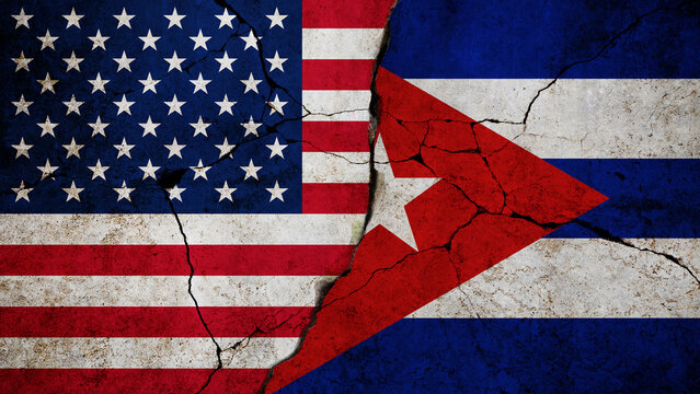 USA and Cuba Flags on Cracked Concrete Wall. Flags of the United States and Cuba painted, cracked concrete texture. political tension, diplomatic conflict, historical sanctions. Concept, war