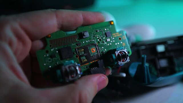A broken game joystick in his hand.