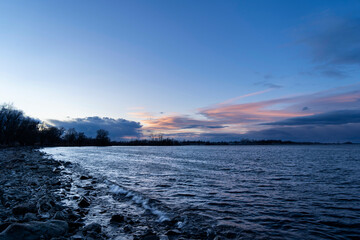 blue hour over Lake Constance Bodensee seen from the border of Bregenz, Vorarlberg, Austria in winter