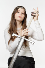 Portrait of a beautiful young princess girl with a sword