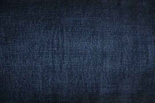 Denim jeans texture or denim jeans background. Dark blue jeans fabric.