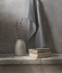 Still life with a gray drapery, a vase, glasses on a light wooden table