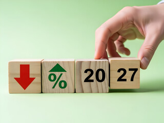 Hand with wooden blocks showing down arrow and percentage for 2027 decline forecast and economic downturn prediction