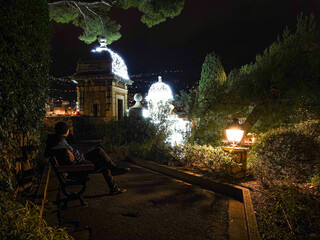 Garden terrace at night with a view of Porte Neuve, Monaco