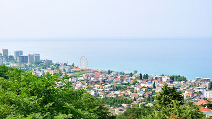 Fototapeta premium View of a coastal city and sea from a high point at summer sunny day.