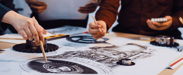 A dynamic scene showcasing a collaborative design process, with hands gesturing over sketches on a table, highlighting teamwork and innovation in a modern workspace. SACTR