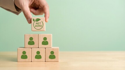 Hand placing Net Zero cube on stack of people icons, environmental concept