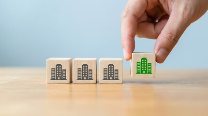 Hand selecting a green building icon cube from a row of grey ones