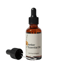 Amber essential oil bottle with dropper in clean studio lighting for wellness branding