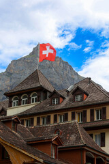 Swiss flag on the roof of a house in Kandersteg, Switzerland